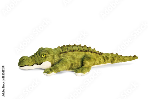Doll of a green combed crocodile on a white background. © lms_lms