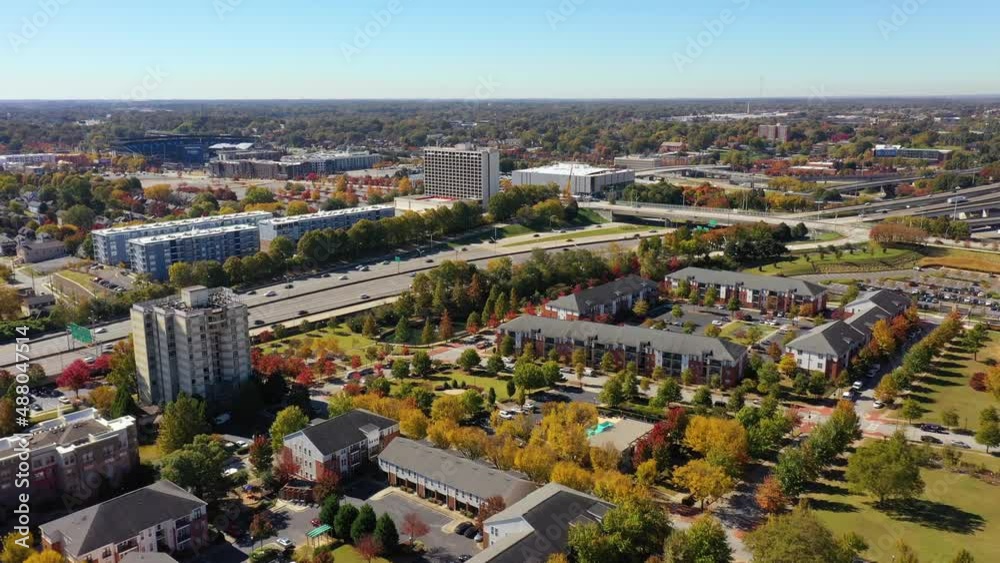 Aerial of highway traffic flowing on a freeway near Atlanta, Georgia with suburbs behind. Aerial of highway traffic flowing on a freeway near Atlanta, Georgia with suburbs behind.
