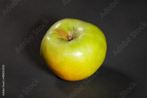 granny smith apple on black background
