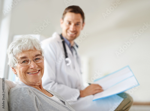 Youre in great hands. Shot of a handsome male doctor with a happy elderly patient.