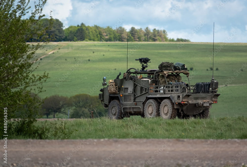 Fototapeta premium An army Supacat HMT 6x6 Coyote rapid assault, fire support and reconnaissance vehicle in action on a military exercise, Wiltshire UK