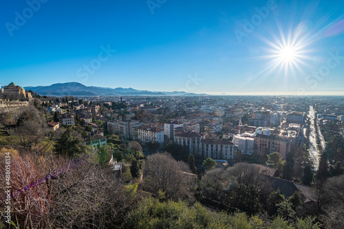 The lower city of Bergamo bassa view from the Saint James Gate in the upper city at sunset, Italy, Europe © Simone