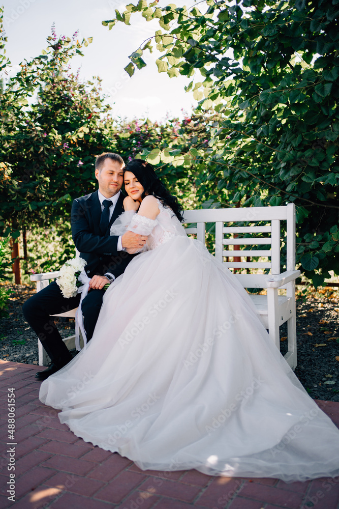 happy newlyweds on a park bench.