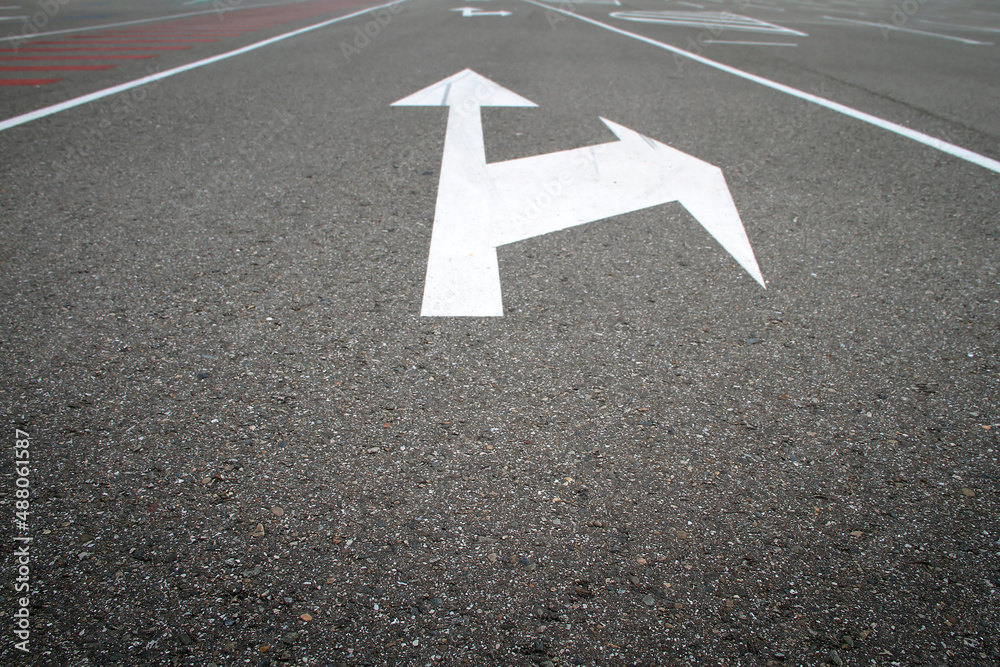 White road markings with direction arrow