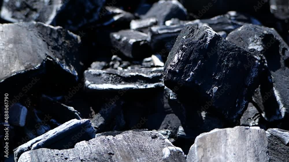 Wood black charcoal burning on a grill in slow motion Wood black charcoal burning on a grill in slow motion