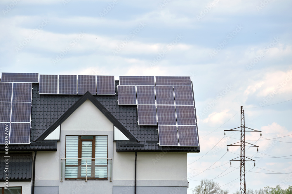 Private home roof covered with solar photovoltaic panels for generating of clean ecological electric energy in suburban rural town area. Concept of autonomous house Private home roof covered with solar photovoltaic panels for generating of clean ecological electric energy in suburban rural town area. Concept of autonomous house