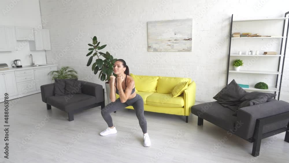Beautiful young woman woman doing abdominal exercises in room