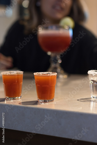 shot of chiliguaro, popular drink from Costa Rica, mixture of guaro, combined with hot chili sauce. photo