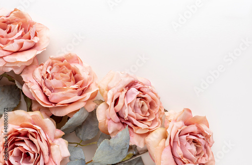 Flowers composition. Bouquet of pink roses in pastel colors. Flatlay.