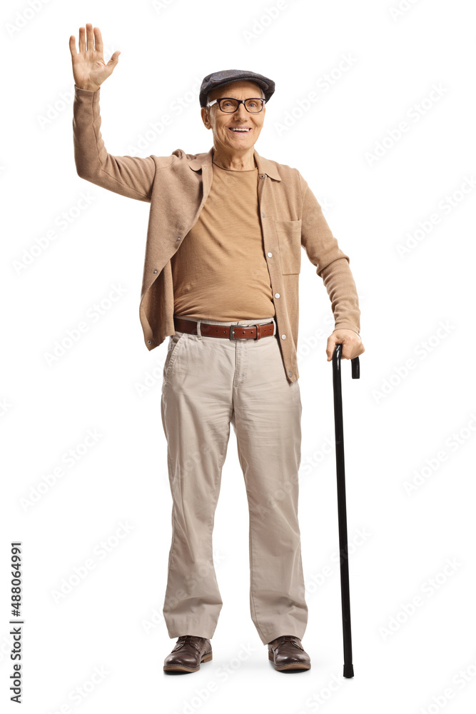 Full length portrait of a smiling elderly gentleman standing with a cane and waving Full length portrait of a smiling elderly gentleman standing with a cane and waving