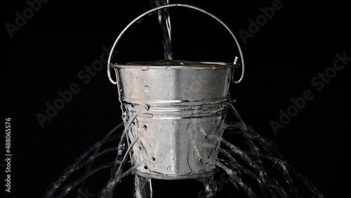 tin bucket with holes on black, real time photo