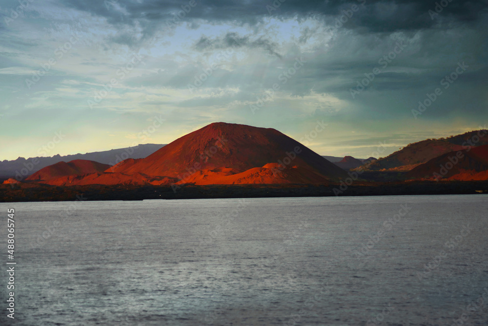Red volcanic Island under a stormy sky in the Galapagos, Bartolome Island Red volcanic Island under a stormy sky in the Galapagos, Bartolome Island