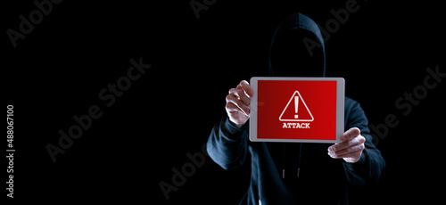 Hacker tablet cyber security. Digital mobile phone in hacker man hand isolated on black banner. Internet web hack technology. Data protection, secured internet access, cybersecurity.