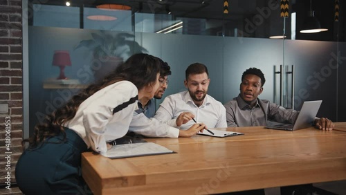 Young ambitious multiracial employees discuss project teamwork startup advertising professionals brainstorming developers working new idea professionals developing business plan coworkers in boardroom