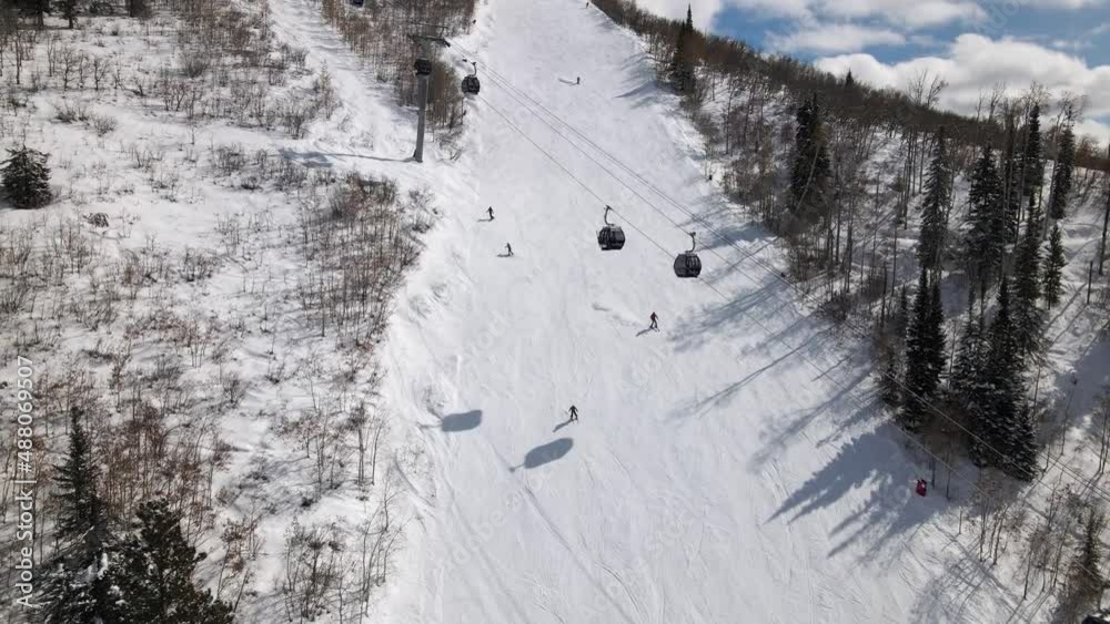 2022 - Excellent aerial view of the ski lift at Steamboat Springs, Colorado and people skiing down the slopes. 2022 - Excellent aerial view of the ski lift at Steamboat Springs, Colorado and people skiing down the slopes.