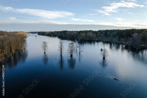 An aerial shot of a lake in Virginia and a kayak paddling through