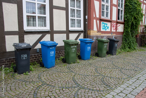 Waste separation in Germany. Various garbage cans in front of houses