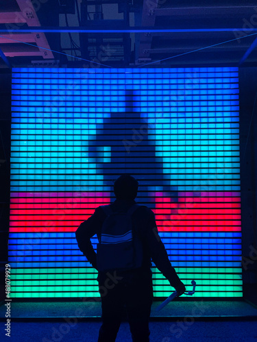 silhouette of a teen guy in the LED background with a gimbal.
