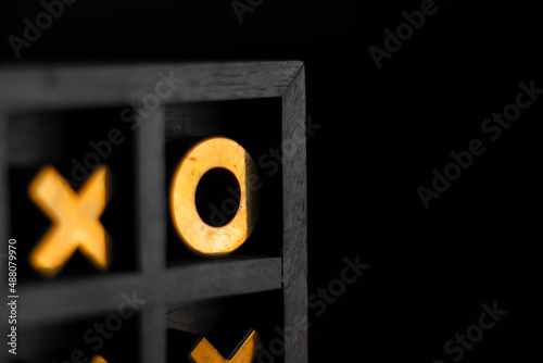 Photos Golden tic-tac-toe wooden board in the smoke.