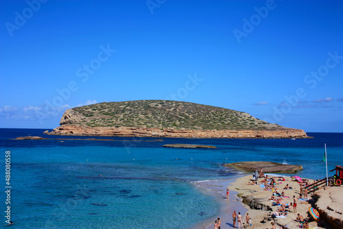 islet of cala conta dipped in the blue of the tourist sea of ​​ibiza in summer photo