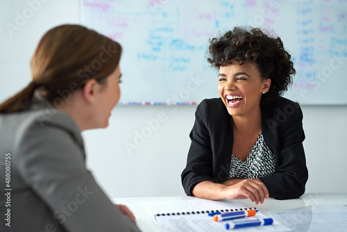 Theyve got great coworker rapport. Shot of two businesswomen enjoying a meeting together at work. photo