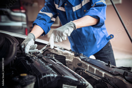 Car care maintenance and servicing, Close-up hand technician auto mechanic using the wrench to repairing change spare part car engine problem and insurance service support.