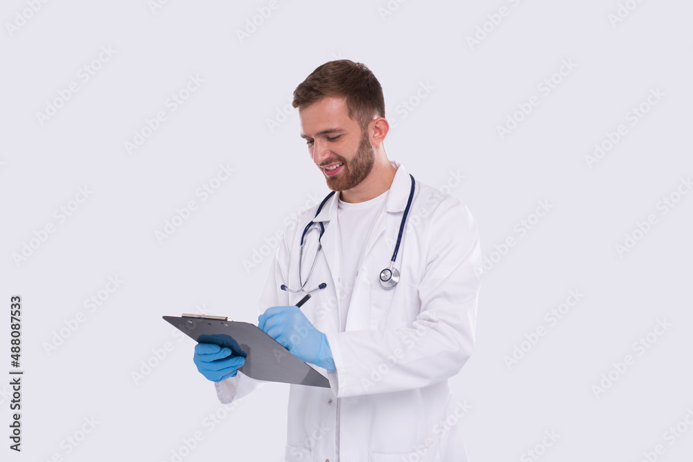 Man Doctor Writing in Clipboard Isolated. Doctor with Clipboard. Commecial, Shopping, Advertisment Concept Isolated Man Doctor Writing in Clipboard Isolated. Doctor with Clipboard. Commecial, Shopping, Advertisment Concept Isolated