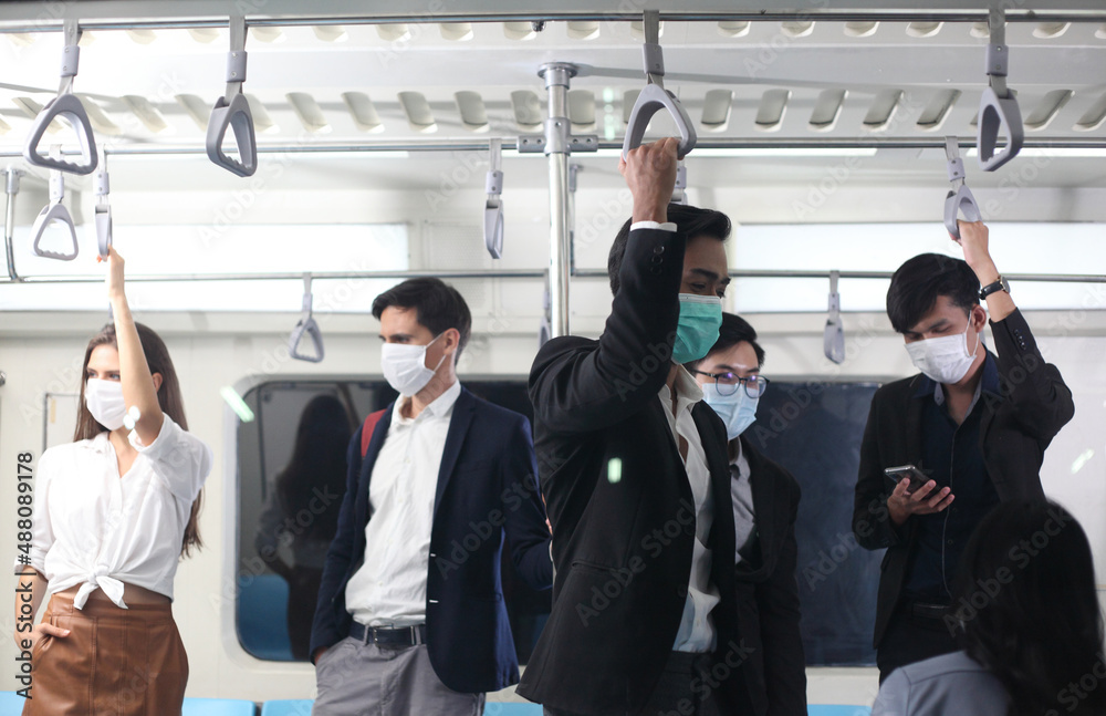 variety of passengers ride the subway car, people with mask in train variety of passengers ride the subway car, people with mask in train