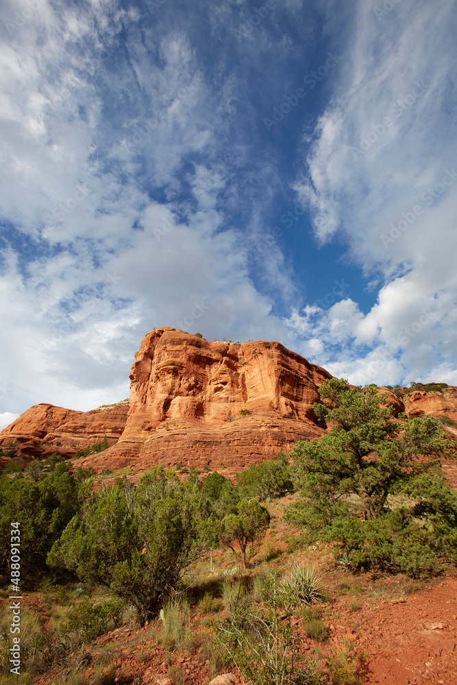 Mountains made of red rocks near Sedona Arizona with a blue sky and perfect clouds as a vertical image Mountains made of red rocks near Sedona Arizona with a blue sky and perfect clouds as a vertical image