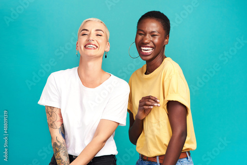 Life is beautiful with your bestie by your side. Studio shot of two happy young women posing together against a turquoise background.