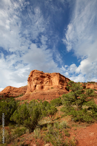 Mountains made of red rocks near Sedona Arizona with a blue sky and perfect clouds as a vertical image