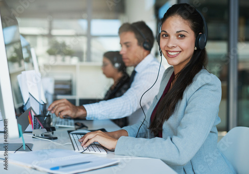 Happy to hear from you. Portrait of a happy and confident young woman working in a call center. © Adene S/peopleimages.com