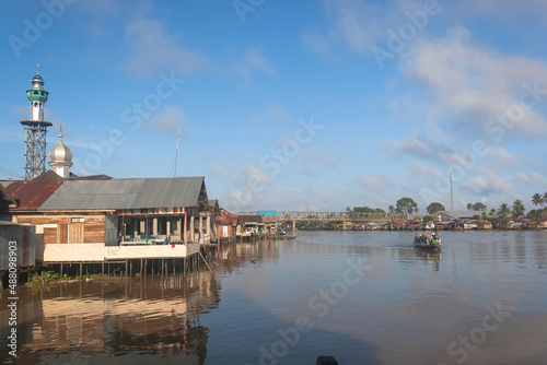 Early morning view and atmosphere, in the village of Banua Anyar with a calm river and blue sky on the banks of the Martapura river, South Borneo, Indonesia. photo