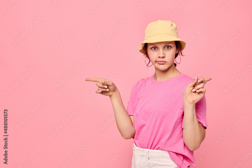 portrait of a young woman in a pink T-shirt and hat Youth fashion