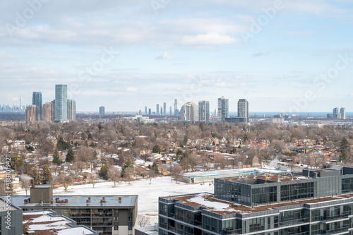 views of downtown Toronto from mimco with snow and trees blue skies lake view and CN tower  in view 