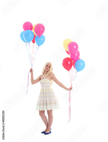  Full length portrait of blonde girl wearing party dress, holding bunch of colourful balloons. Isolated on white studio background © faestock