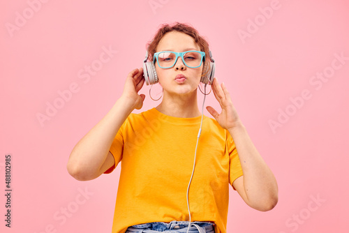 cheerful woman wearing headphones blue glasses close-up emotions Lifestyle unaltered