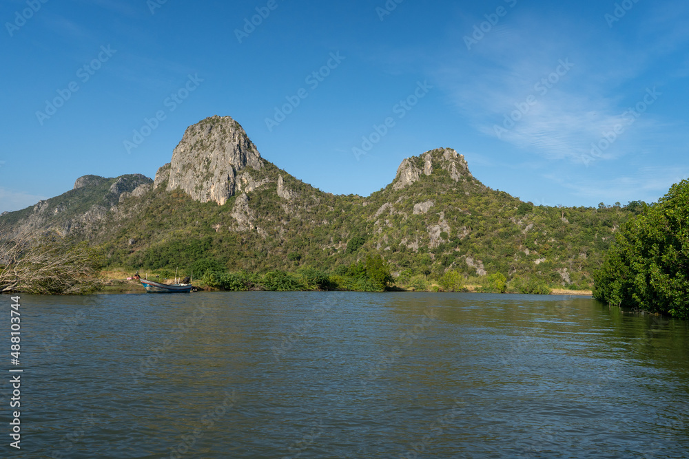 along with river side of mangrove forest with green moutain and clear blue sky