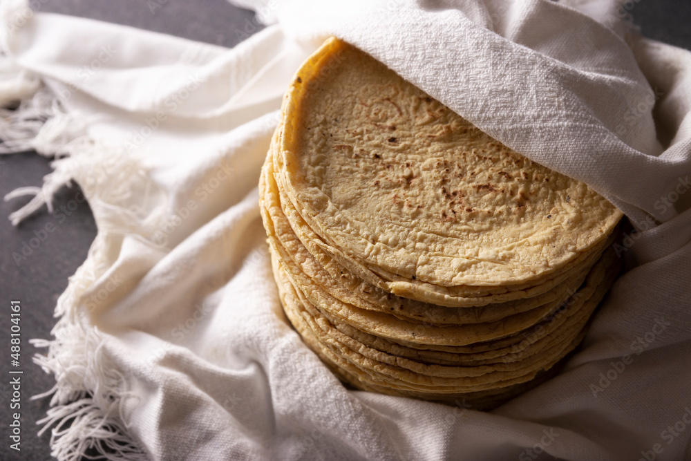 Corn Tortillas. Food made with nixtamalized corn, a staple food in several American countries, an essential element in many Latin American dishes. Corn Tortillas. Food made with nixtamalized corn, a staple food in several American countries, an essential element in many Latin American dishes.
