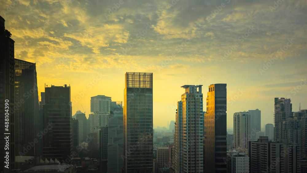 Spectacular panoramic views of the skyscrapers in Bangkok. In the early morning as the sun rises behind tall buildings.