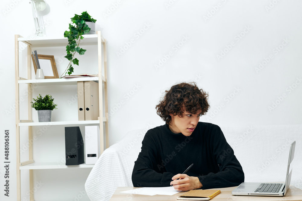 man on a white sofa in front of a laptop learning communication man on a white sofa in front of a laptop learning communication