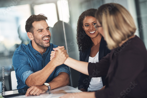 Strong partners make a strong business relationship. Shot of a businesswoman and businessman shaking hands during a meeting in a modern office.