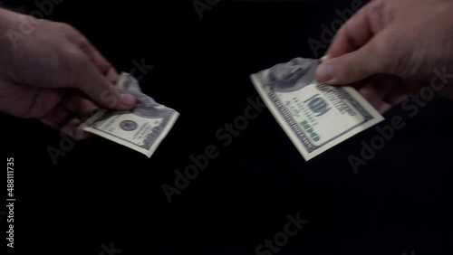 4K view of hands tearing up a hundred dollar bill.