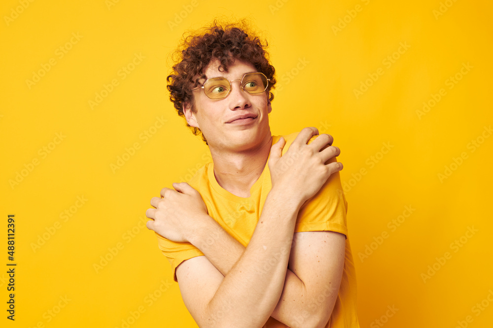 cute red-haired guy yellow t-shirt glasses fashion hand gestures isolated background unaltered cute red-haired guy yellow t-shirt glasses fashion hand gestures isolated background unaltered