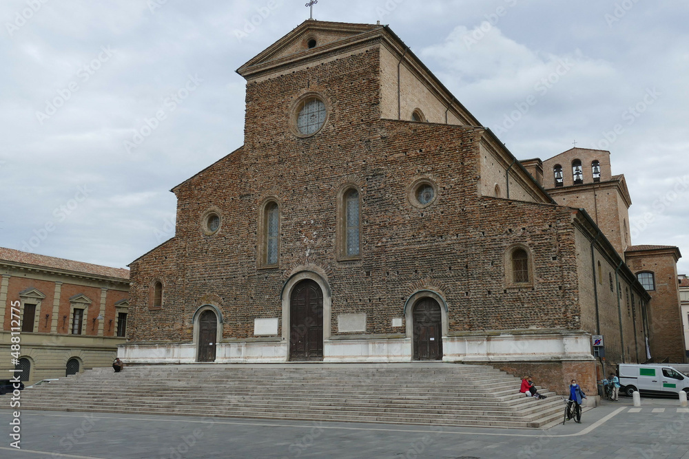 St. Peter Cathedral in Faenza, the facade unfinished built by rough brick, and with in front the staircase and the square