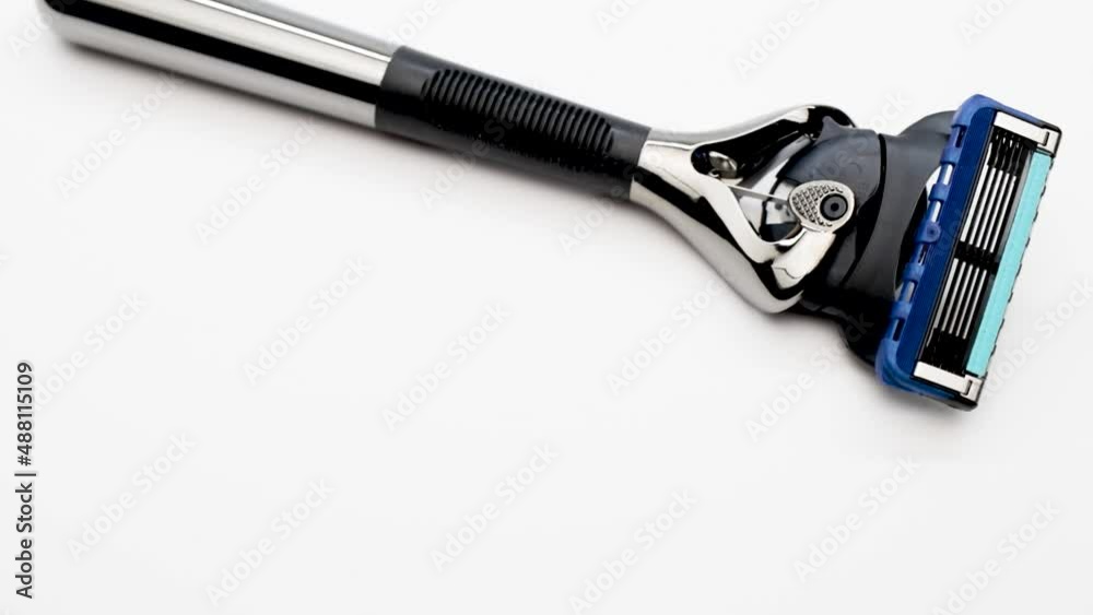 Modern men's razor with a lot of blades on a white background. Gift for the modern man. Body and beard care. Blitz machine. Modern men's razor with a lot of blades on a white background. Gift for the modern man. Body and beard care. Blitz machine.