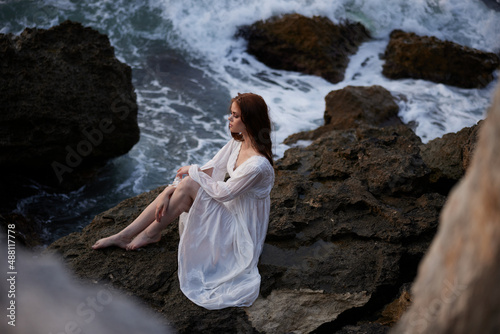 Woman in white dress rocky company nature ocean waves