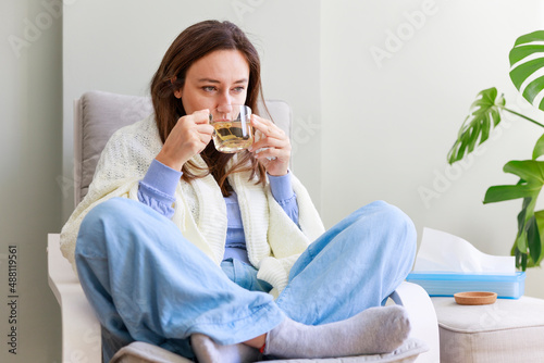 Woman drinking herb tea photo