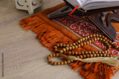 Composition of Muslim worship equipment on a wooden background