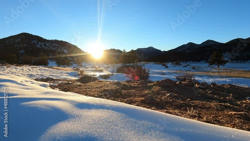 Sunrise over distant peaks in Snowy Moraine Park Colorado